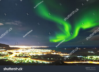 stock-photo-northern-lights-above-reykjavik-iceland-176694704.jpg