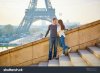 stock-photo-young-loving-couple-in-paris-holding-hands-near-the-eiffel-tower-294656123.jpg